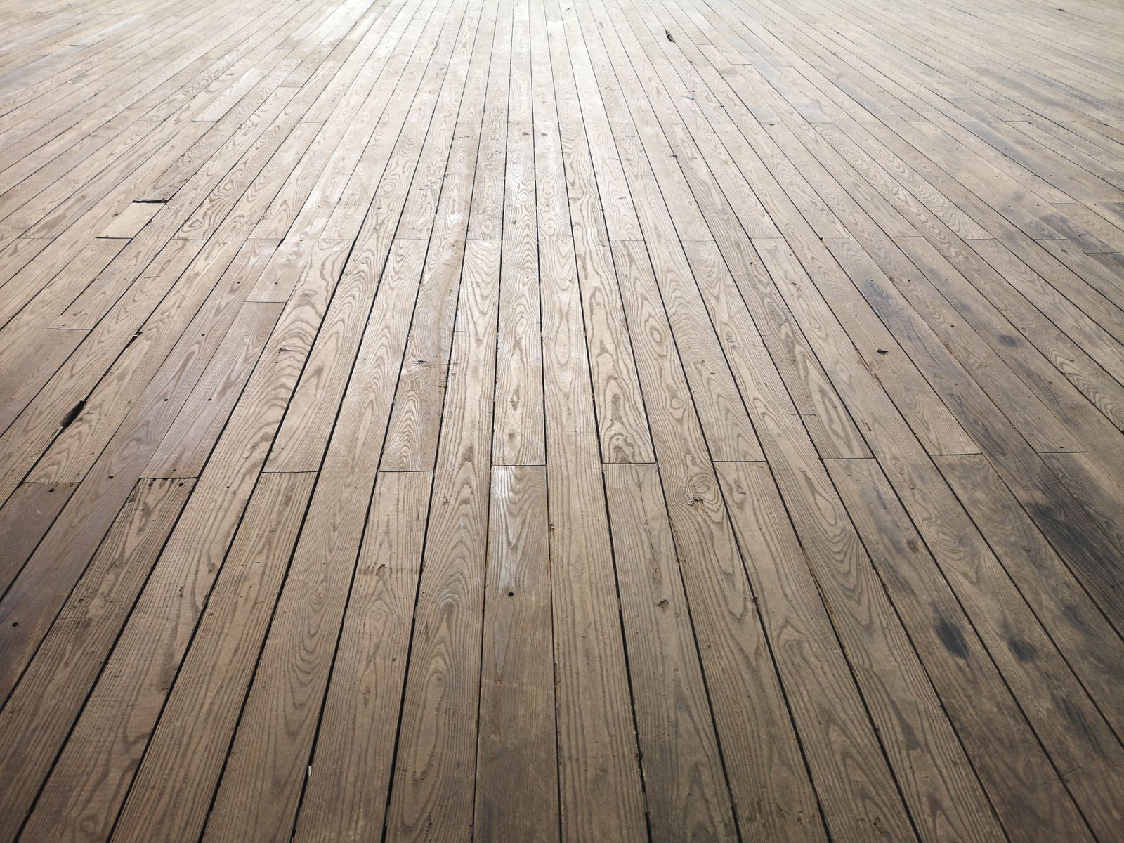 Hardwood floor planks being installed in a renovated room