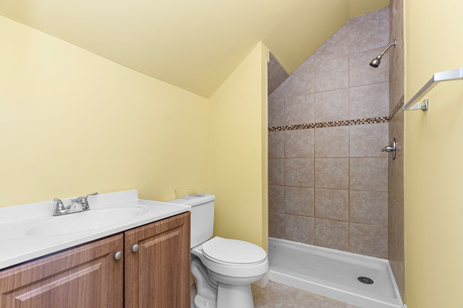 Renovated bathroom with tiled walk-in shower and a floating vanity