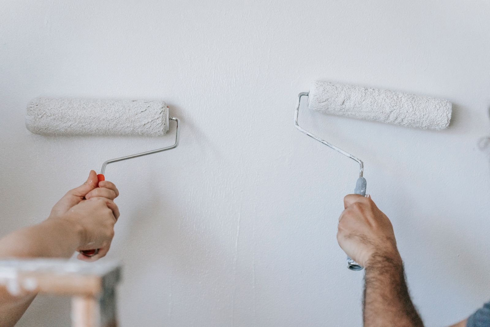 Painter rolling fresh paint onto an interior wall